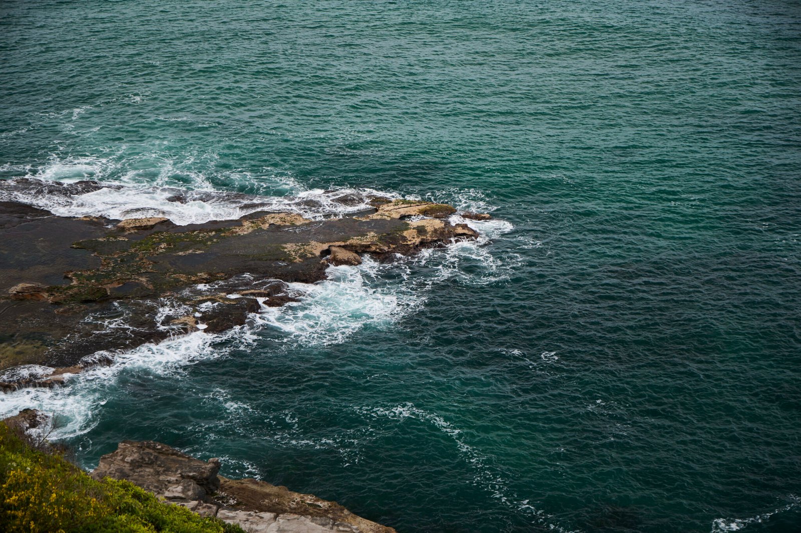 Waves crashing against cliffs at Royal National Park coastline