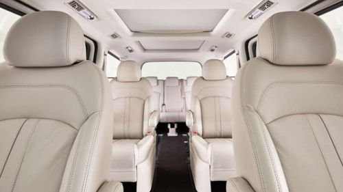 Plush white leather seats inside private tour van